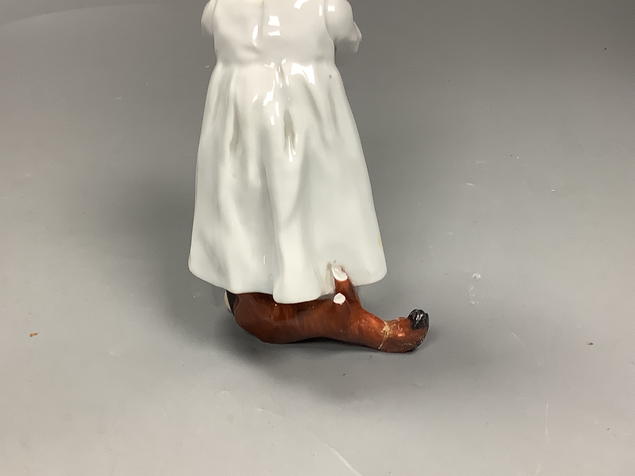 A Meissen figure of a child drinking from a bowl, modelled by Konrad Hentschel, c.1905-1924, 16cm high, faults